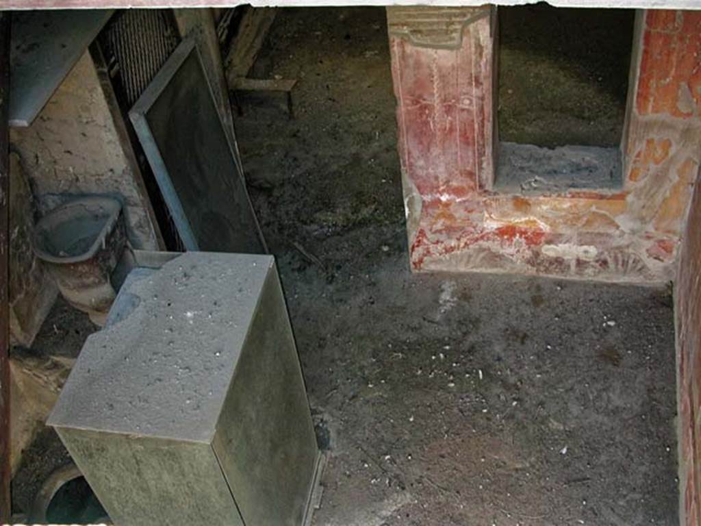 V.17, Herculaneum. September 2003. Looking towards south wall of shop-room, from upper floor. 
On the left, near the east wall beneath the stairs up to V.18, can be seen a dolium buried in th floor, as well as a terracotta oven.
Photo courtesy of Nicolas Monteix.